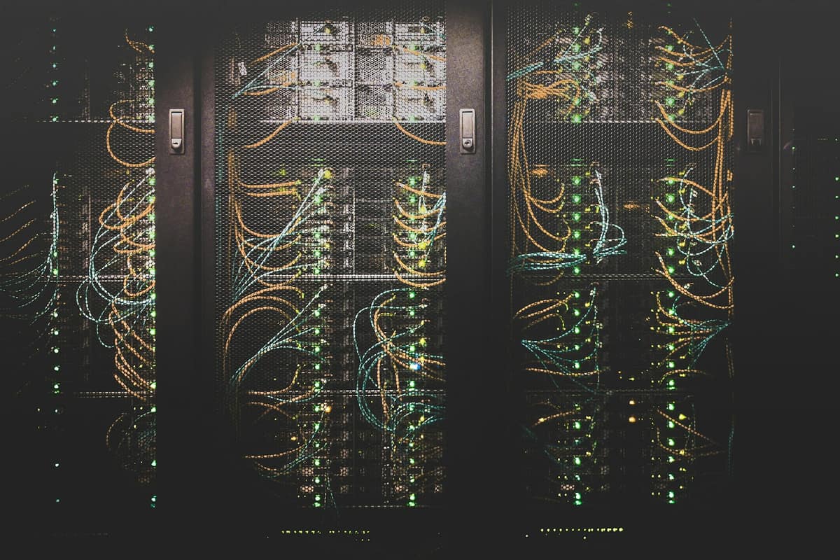 Rows of server racks with status lights in a data centre