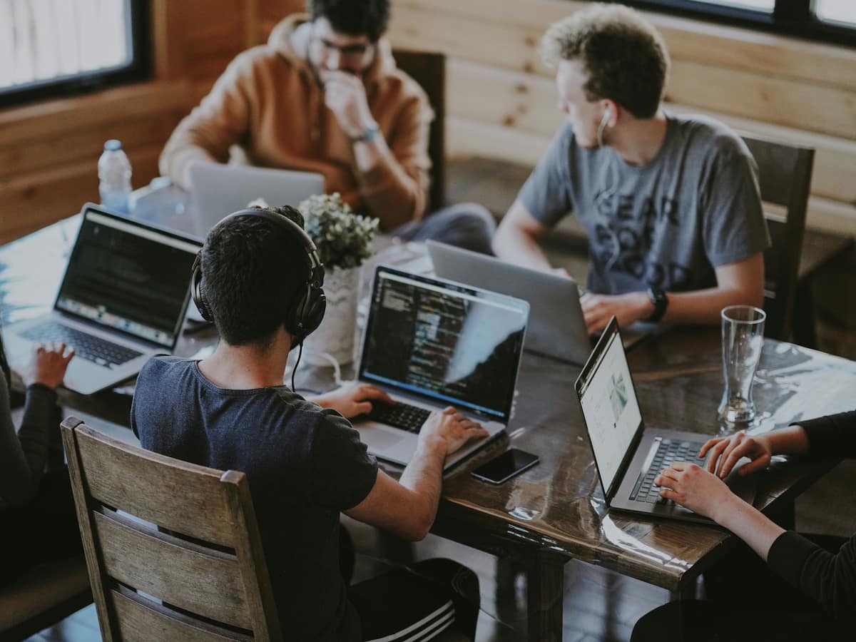 A product team working together around laptops at a shared table